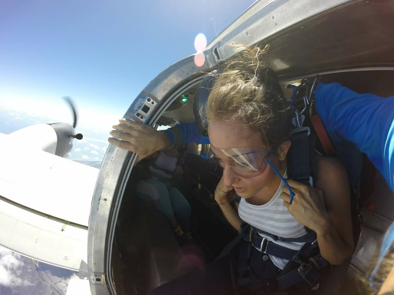 Woman in a plane about to go skydiving