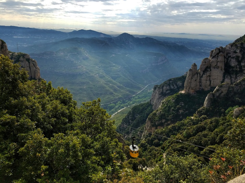 View of yellow Aeri de Montserrat cable car with valley view below